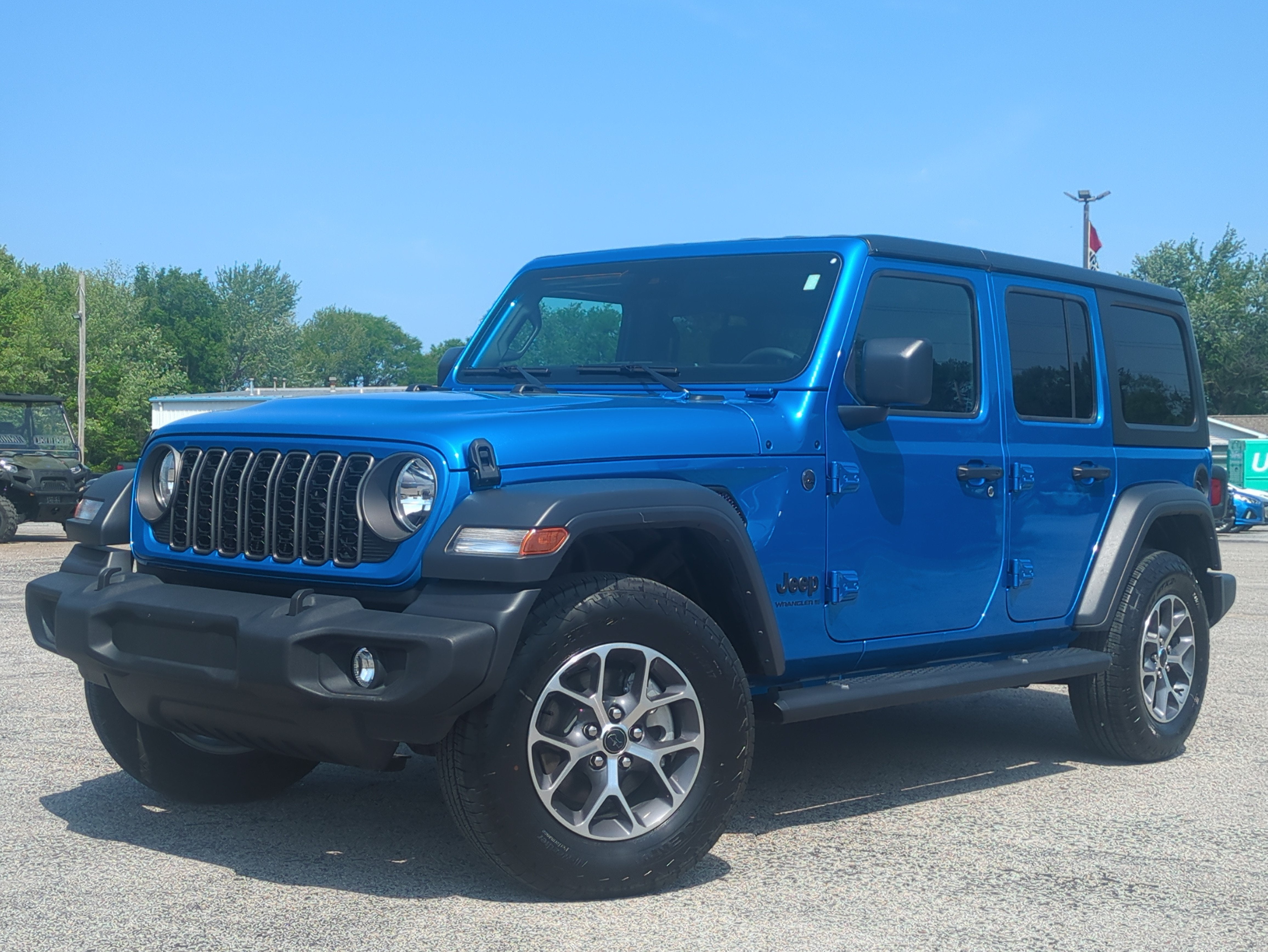 2024 Jeep Wrangler 4-Door Sport S 4x4 in Hydro Blue Pearlcoat — front three-quarter view