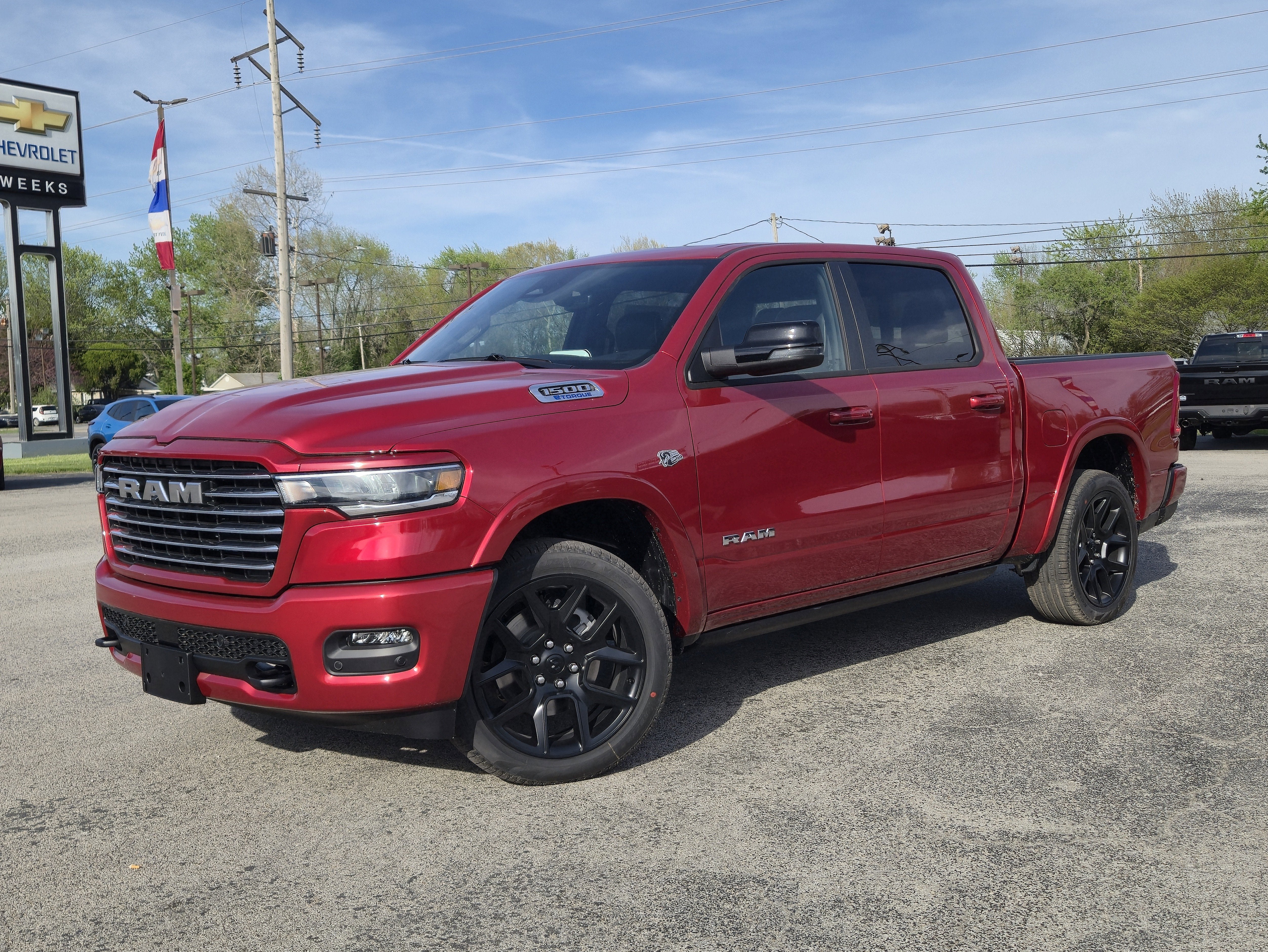 2026 RAM Ram 1500 RAM 1500 LARAMIE CREW CAB 4X4 5'7' BOX in Molten Red Pearl-Coat Exterior Paint — front three-quarter view