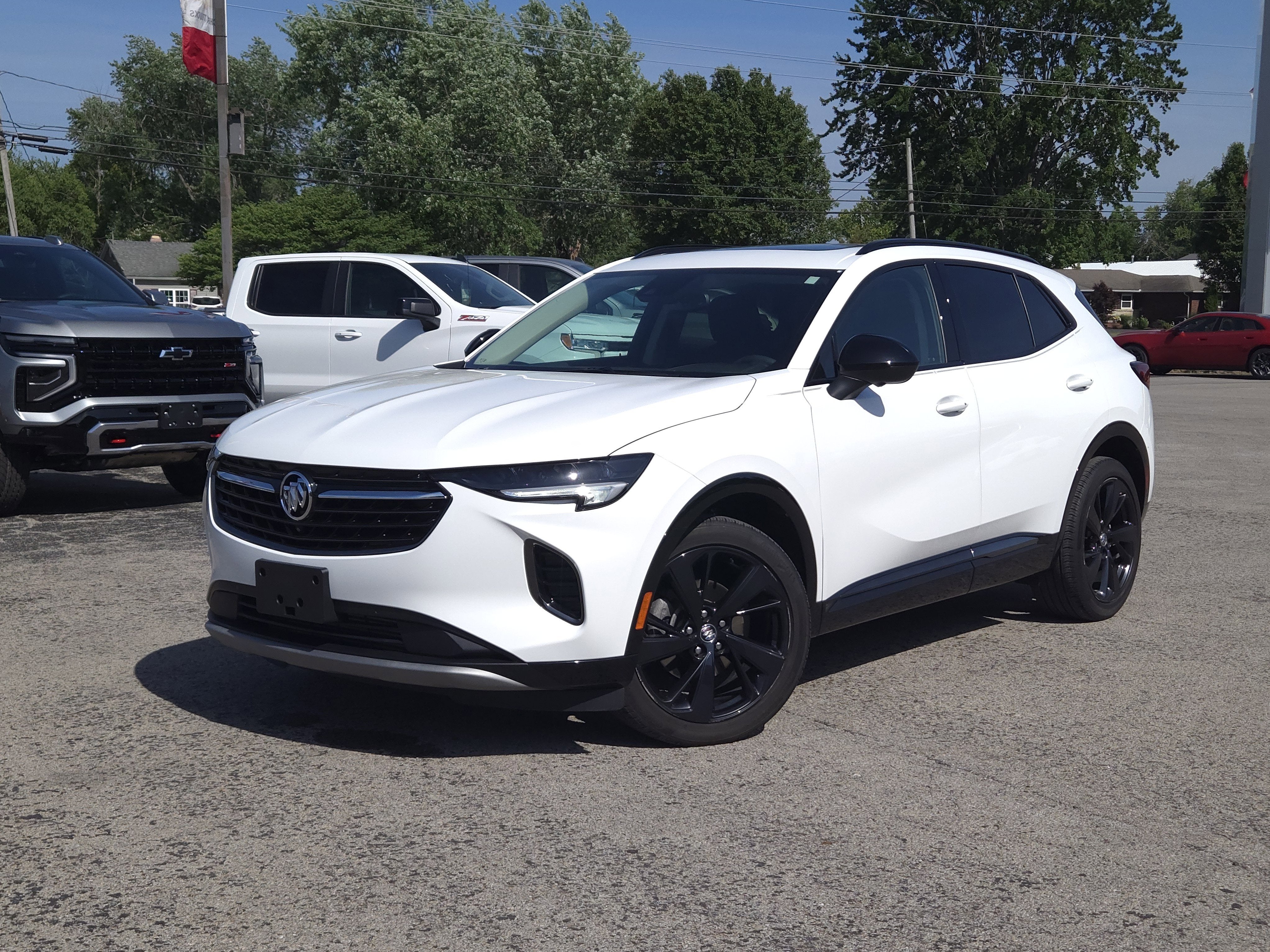 2023 Buick Envision Essence AWD in Summit White — front three-quarter view